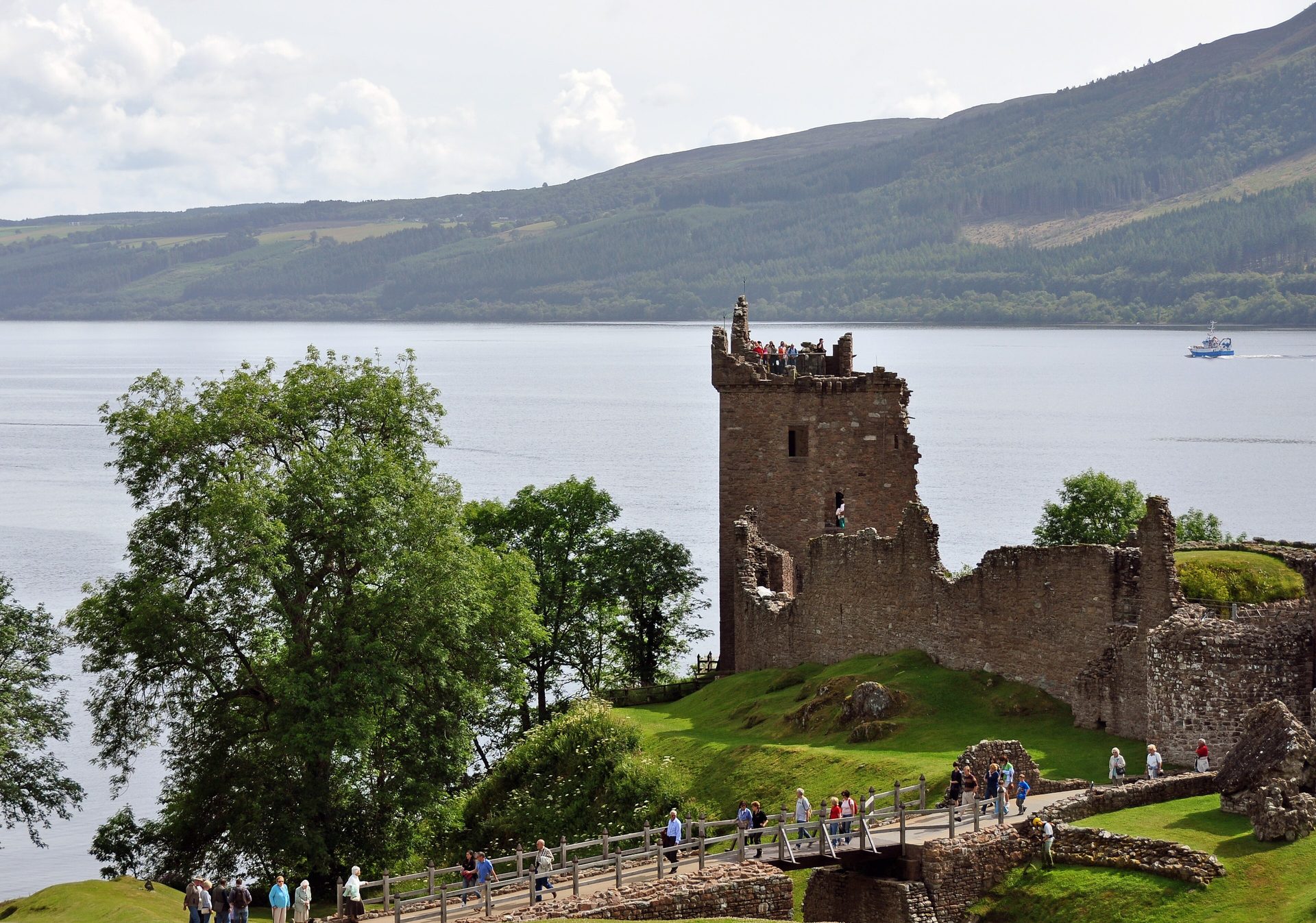 Urquhart Castle ruins on the shore of Loch Ness at golden hour, Scottish Highlands